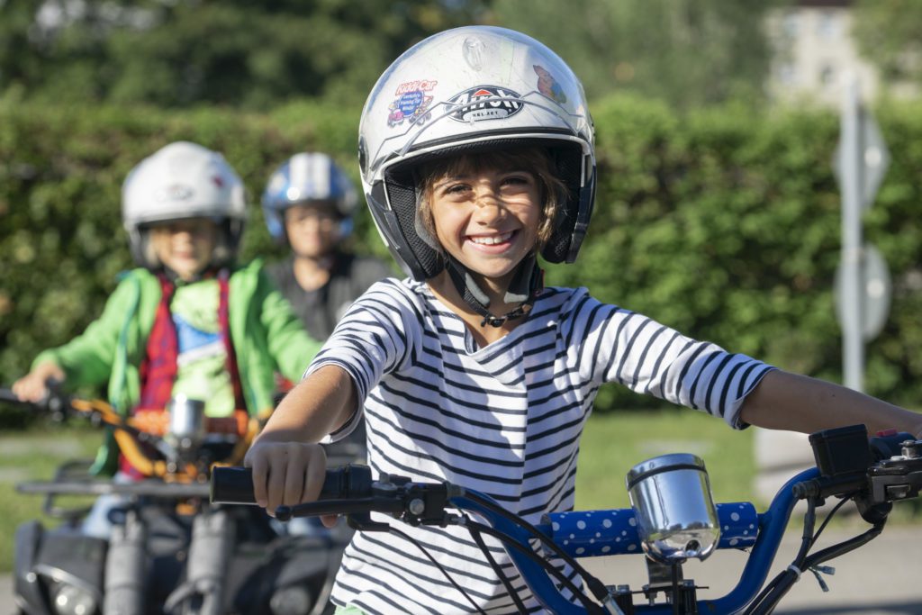 Mädchen sitzt auf Quad und lächelt